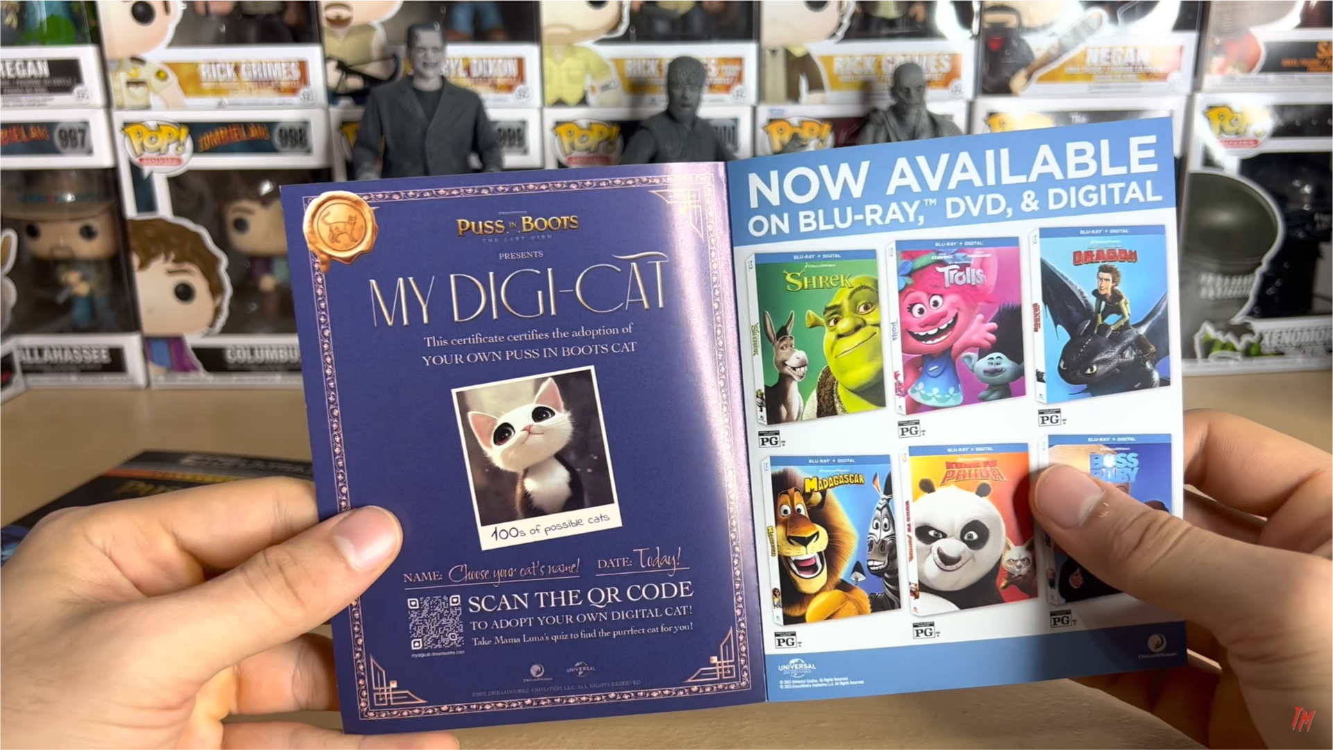 Hand holding a brochure of advertising the movie and the game.